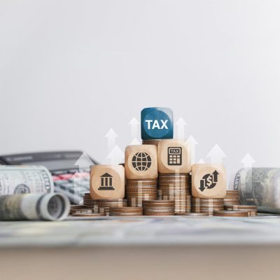 Tax concept with icons on wooden blocks Tax reduction planning, expenses, accounting, VAT and property taxes. Request a tax refund and submit taxes for online tax documents to the government.